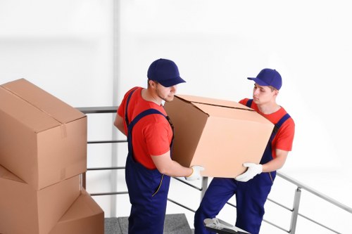 Removal team loading household items into a vehicle for a booked move