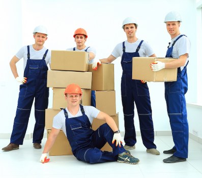 Professional movers transporting office equipment during a Bermondsey relocation