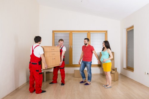 Mover using PPE while handling heavy furniture in Bermondsey