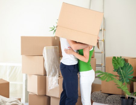 Staff using safe lifting techniques while moving furniture