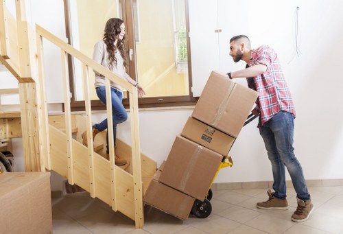 Specialist movers managing a grand piano removal with equipment
