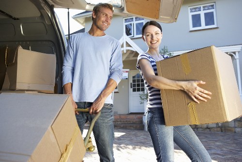 Removal team carrying furniture through a Bermondsey apartment building